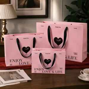 China Custom Pink Heart Paper Gift Bags with Black Ribbon Handles Manufacturer, Manufacturers