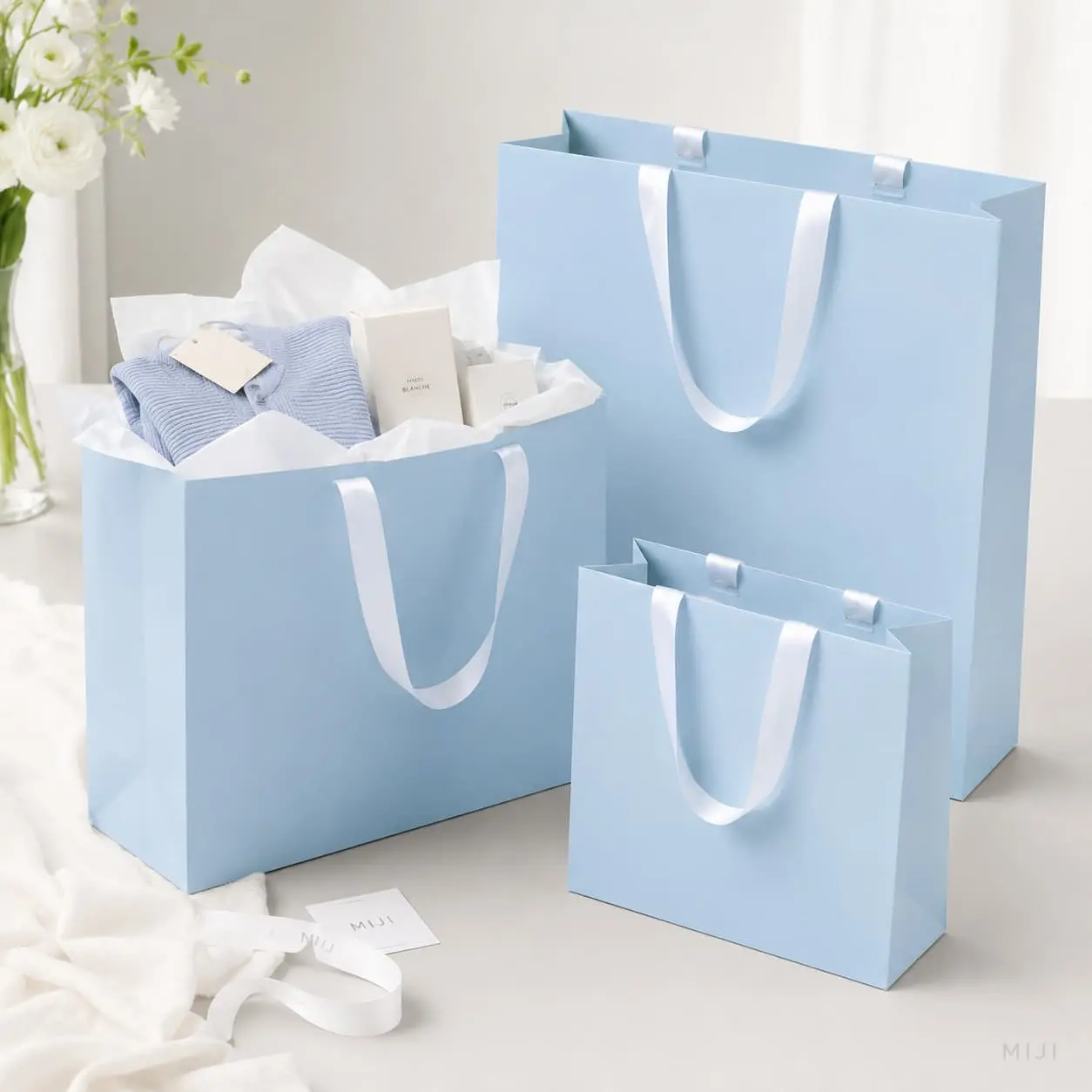 China Custom Light Blue Paper Gift Bags with White Ribbon Handles Manufacturers, Suppliers