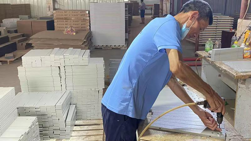 Furniture assembly process — skilled workers assembling dining furniture at Oakes