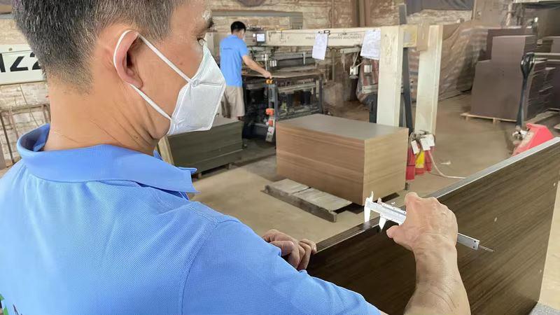 Quality control inspection of furniture products at Oakes Furniture factory