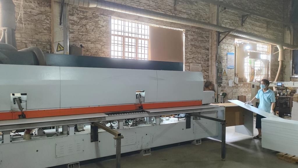 Edge bonding machine for furniture panel finishing at Oakes manufacturing
