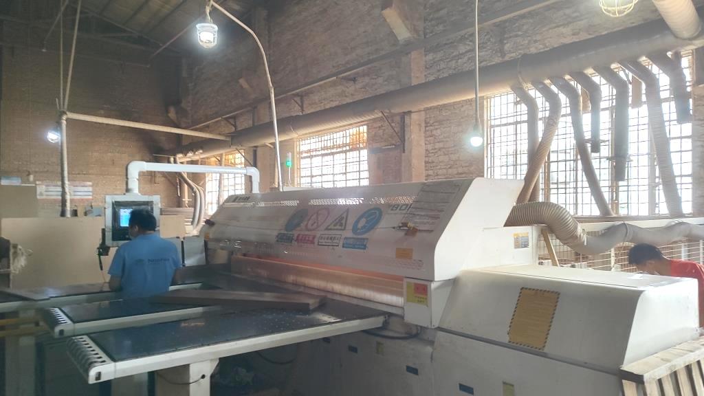Automated cutting machine for furniture panel processing at Oakes Furniture factory