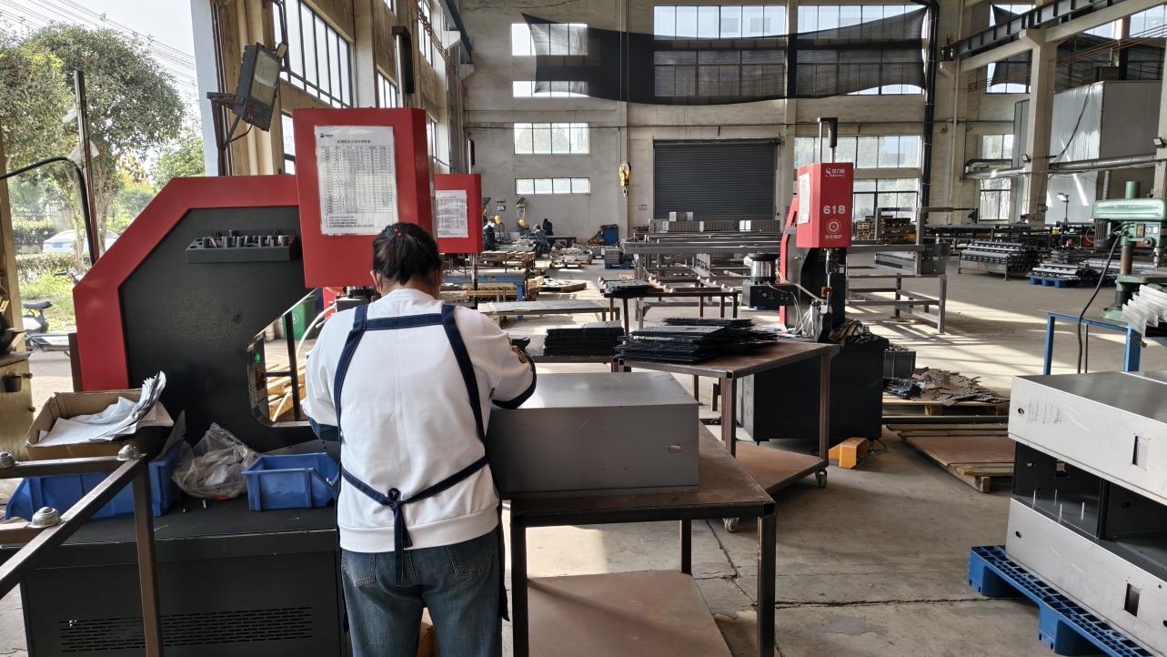 Riveting machine for solar enclosure assembly