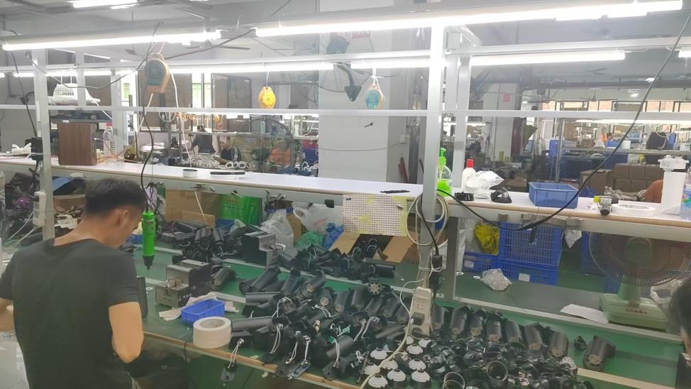LED light assembly process at Pina Light factory — technicians assembling LED driver components