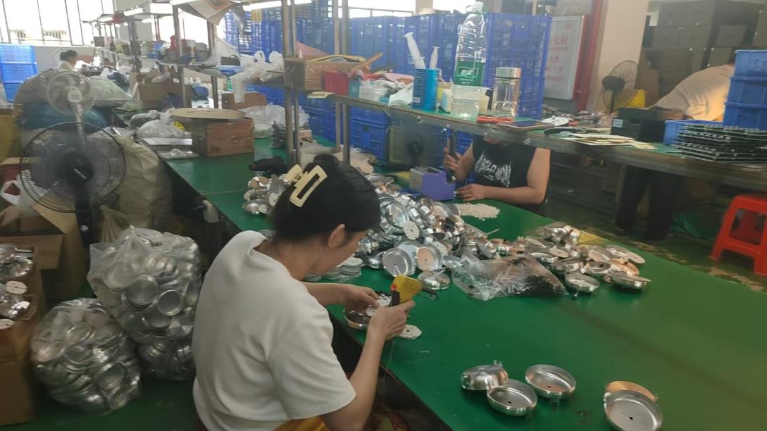 LED driver and heat sink assembly at Pina Light — precision mechanical assembly workstation