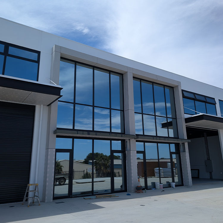 Commercial warehouse office window wall floor to ceiling large panel fixed storefront shopfront with tempered tinted glass