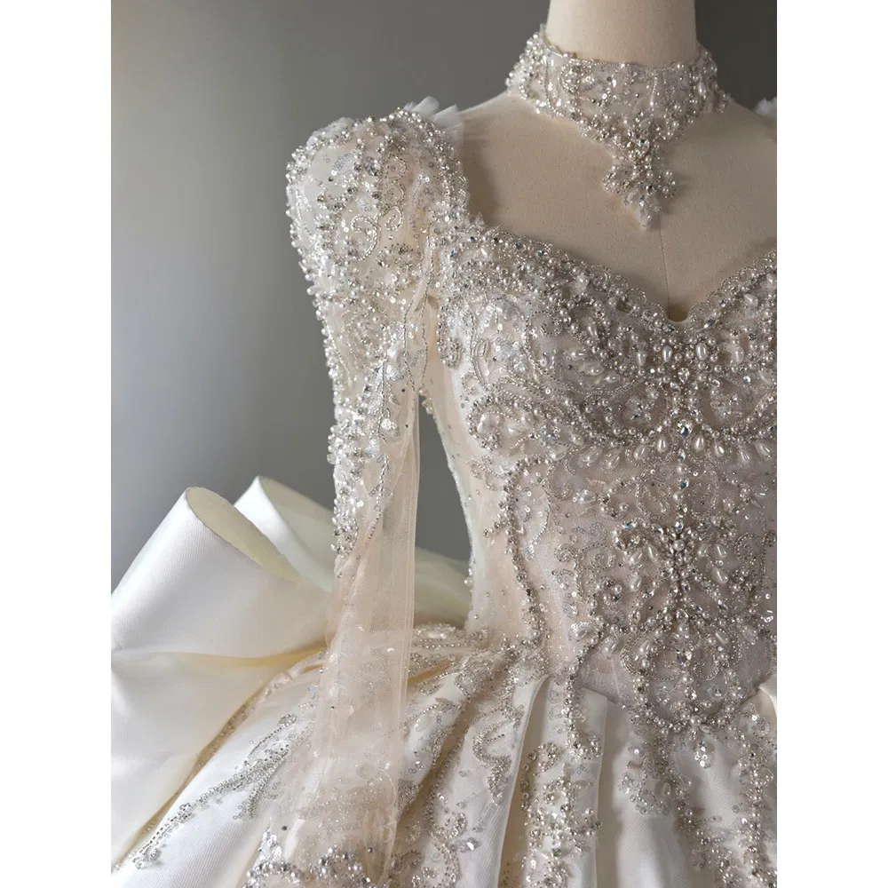 Vestido de novia de bola de encaje con mangas largas, perlas y cristales para mujeres