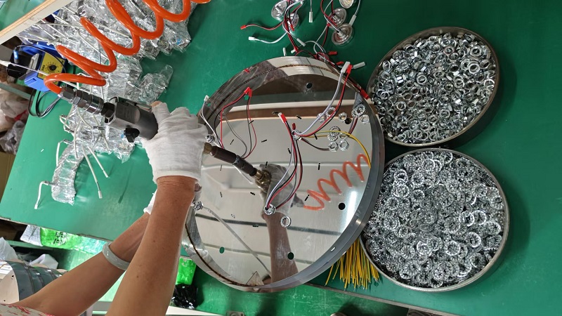 SciBrite LED lighting component assembly station workers