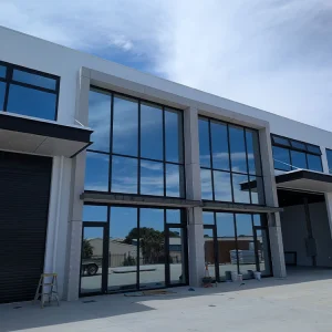 Commercial warehouse office window wall floor to ceiling large panel fixed storefront shopfront with tempered tinted glass