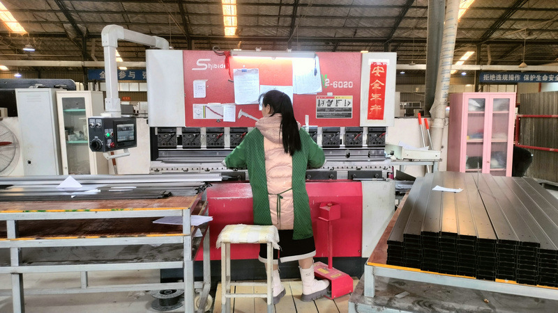 Automated bending machine forming racking structural components