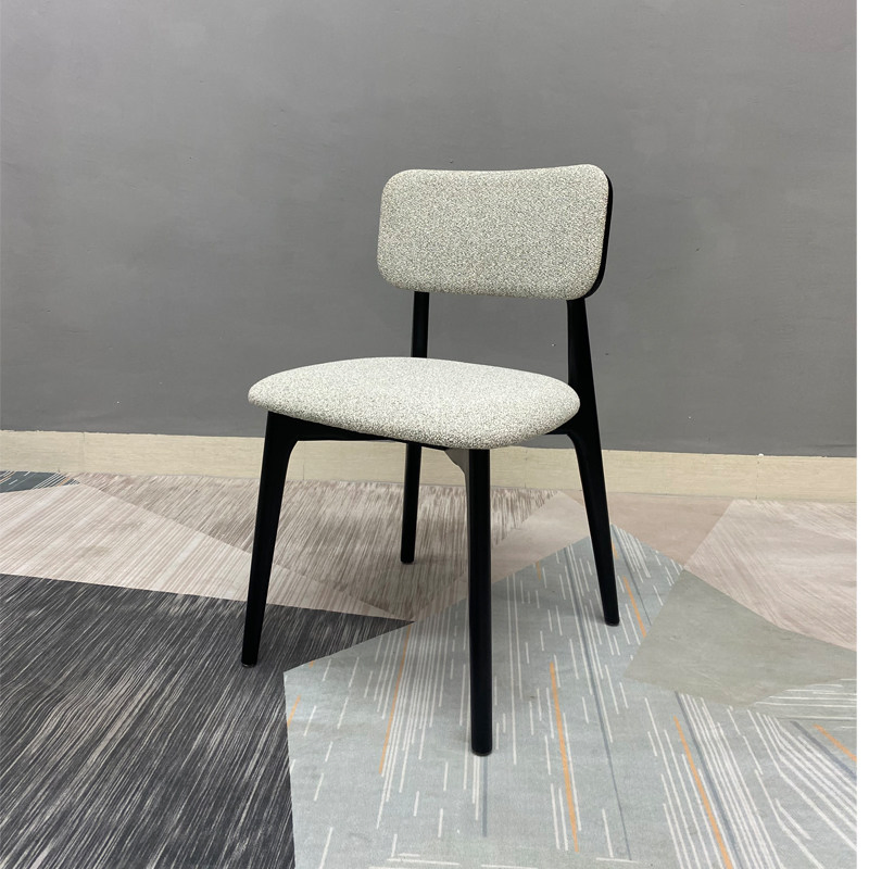 The Reading Nook Dining Chair That Transitions From Dining Table to Living Room Corner with a Cozy Wrapped Back That Feels Enclosing