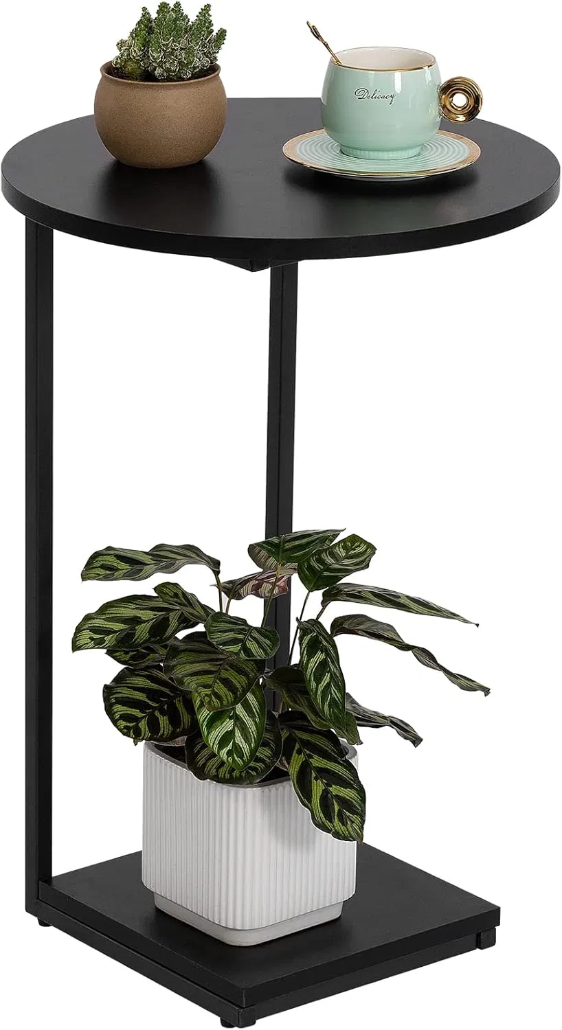 Round Accent Table with a Feline Vase and Coffee Cup for a Bright Reading Nook by The Window