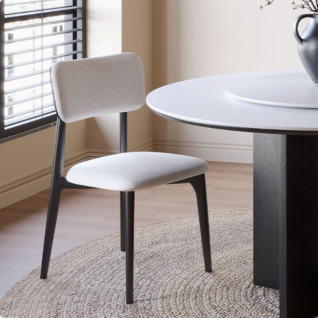 The Reading Nook Dining Chair That Transitions From Dining Table to Living Room Corner with a Cozy Wrapped Back That Feels Enclosing