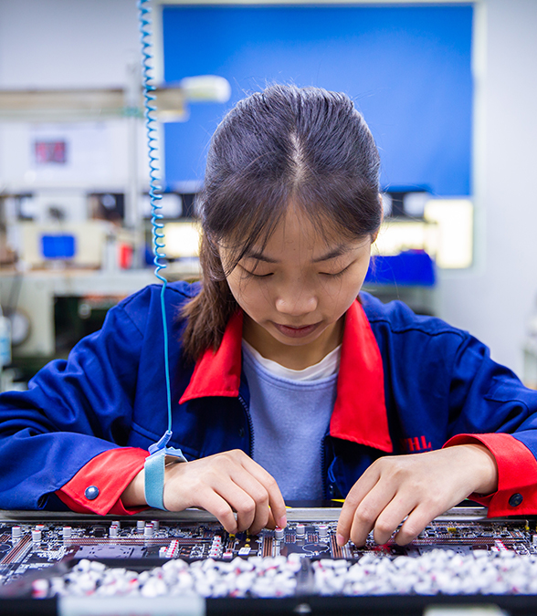 STHL engineers inspecting PCB assemblies on the production floor