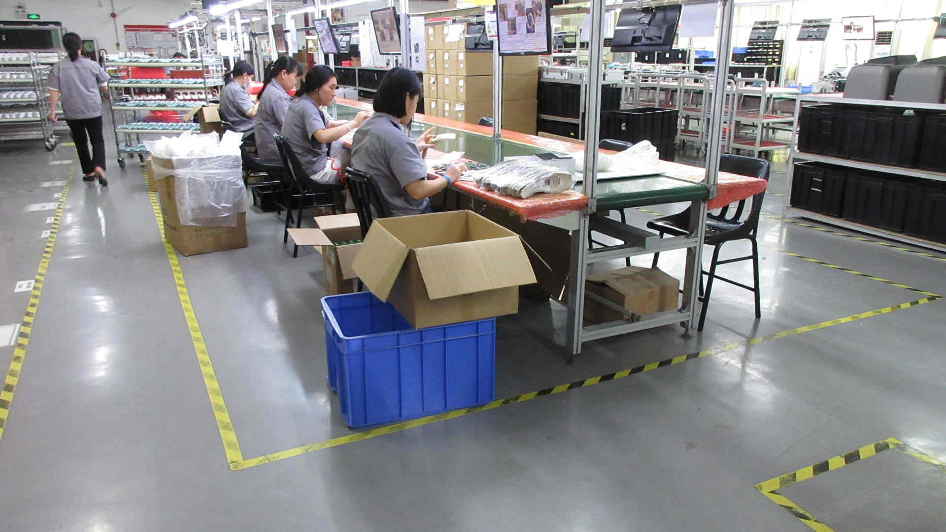 Skilled technicians assembling professional beauty devices on the V-Cest production line