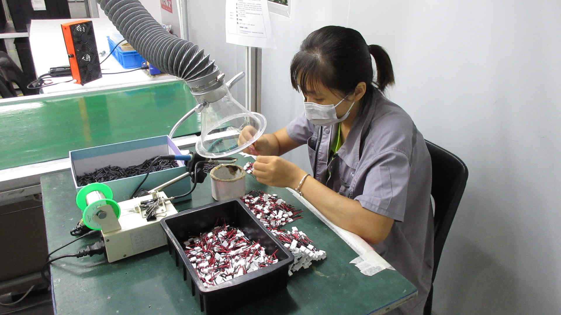 Professional welding process for aesthetic device circuit boards at V-Cest Beauty manufacturing facility