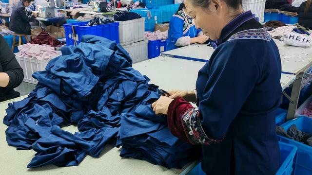 Quality control inspection of activewear garments at Wearth Apparel factory