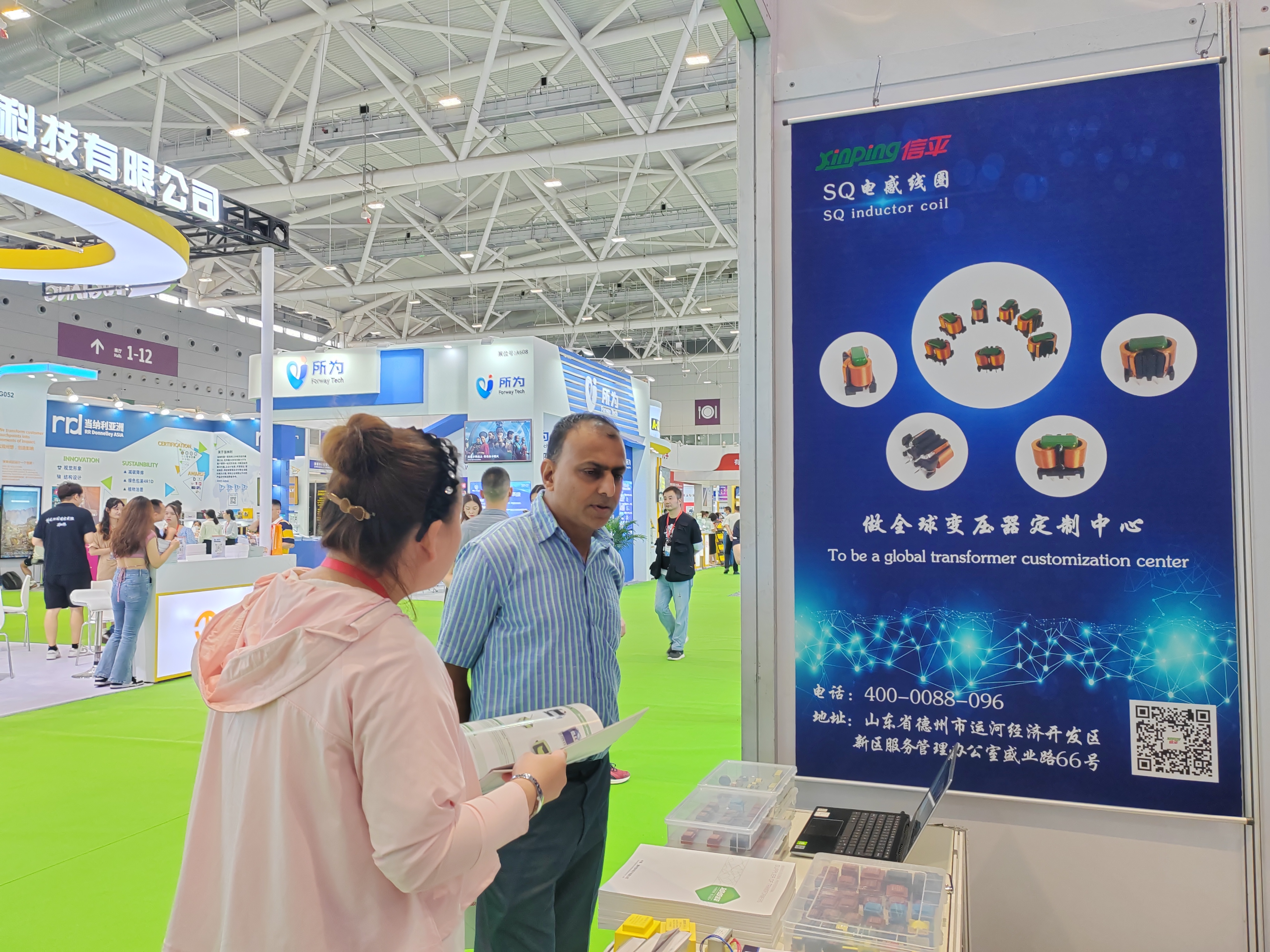 Xinping Electric exhibition team presenting transformer solutions at trade show
