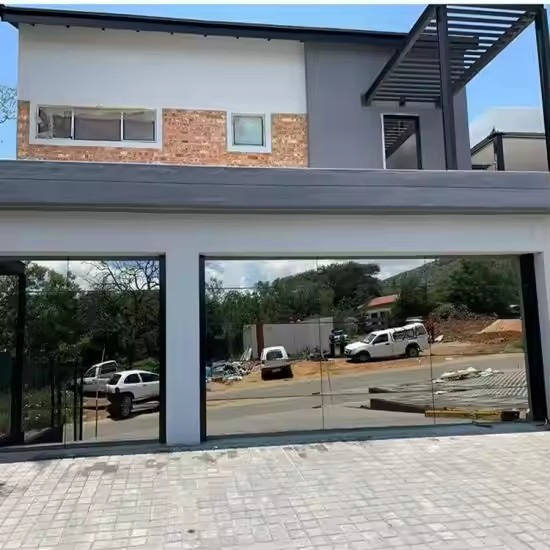 Guangdong Modern Black Frameless Flush Aluminum Security Garage Door with Mirror Glass View